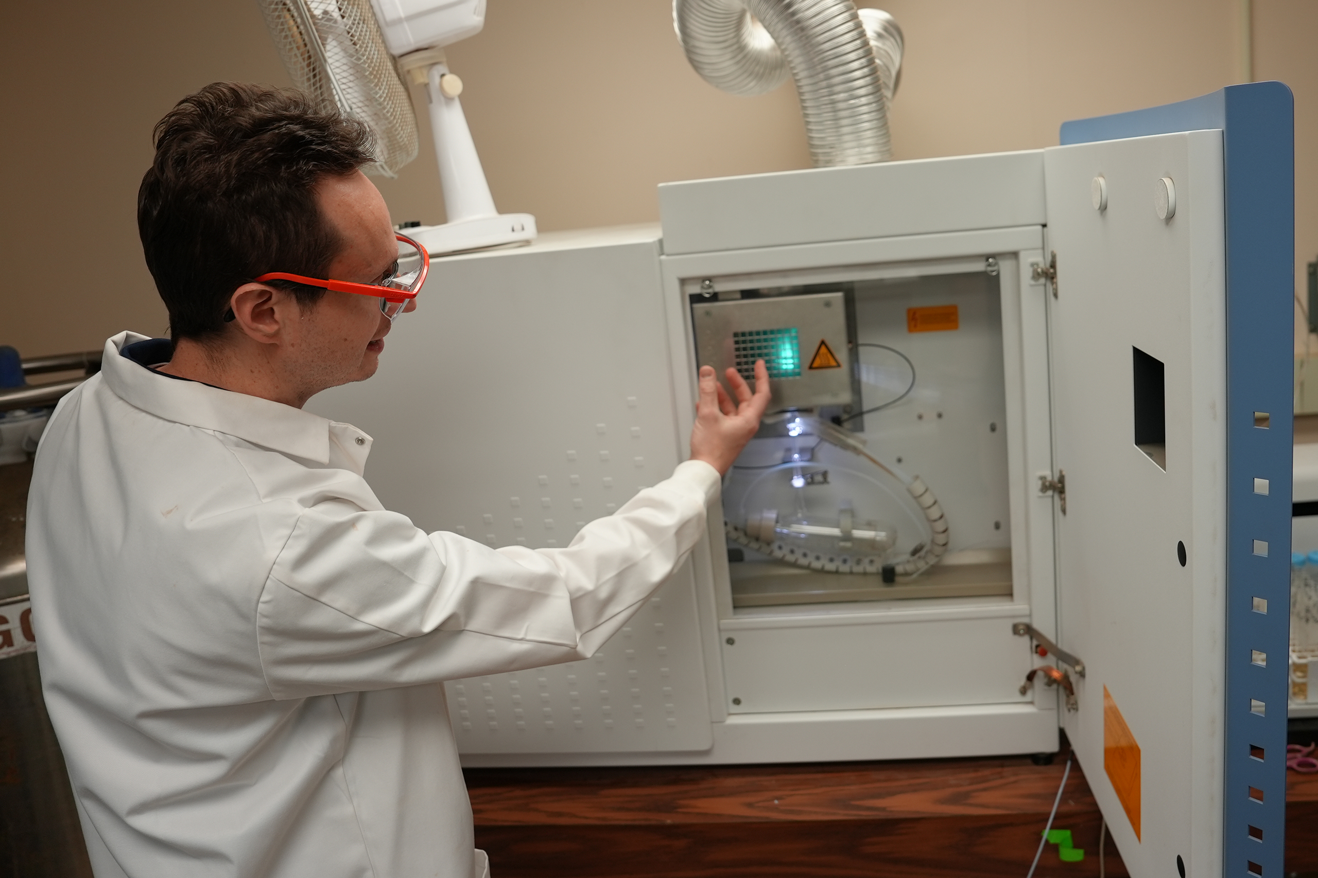 lab technician loading soil samples into lab equipment